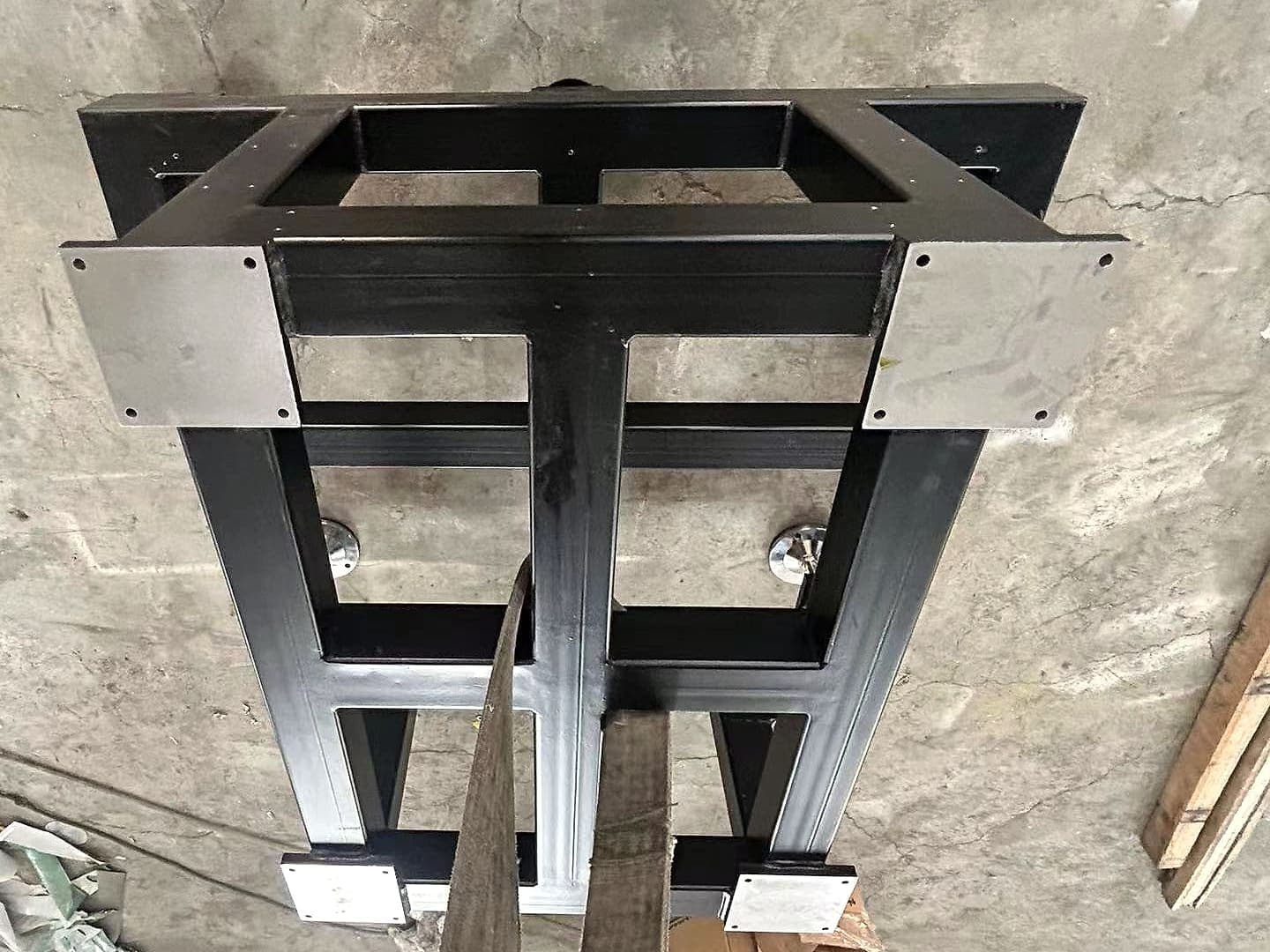 Dark rectangular metal frame on a concrete floor