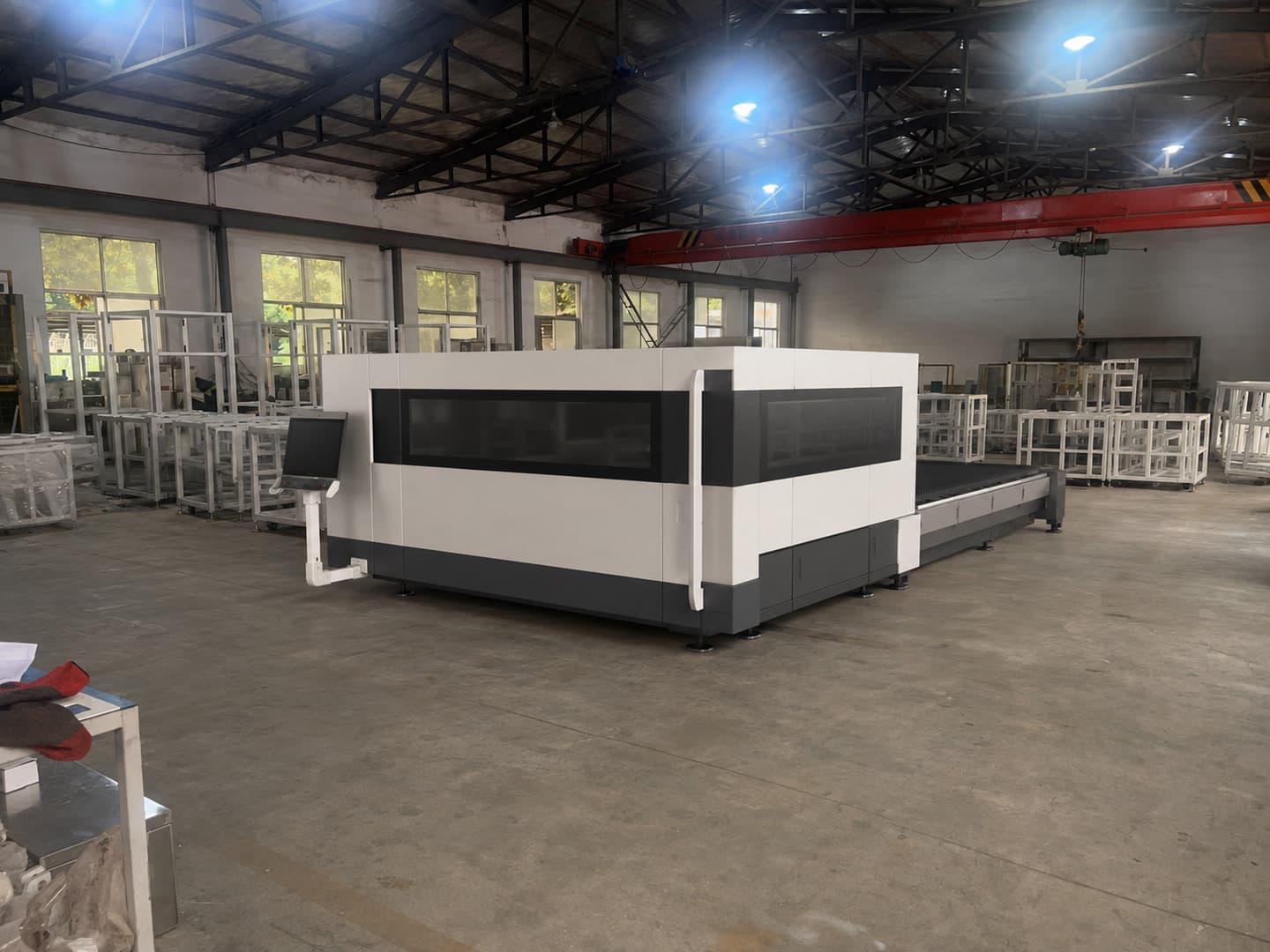 Illustrative configuration of an enclosed sheet-metal laser-cutting station in a factory