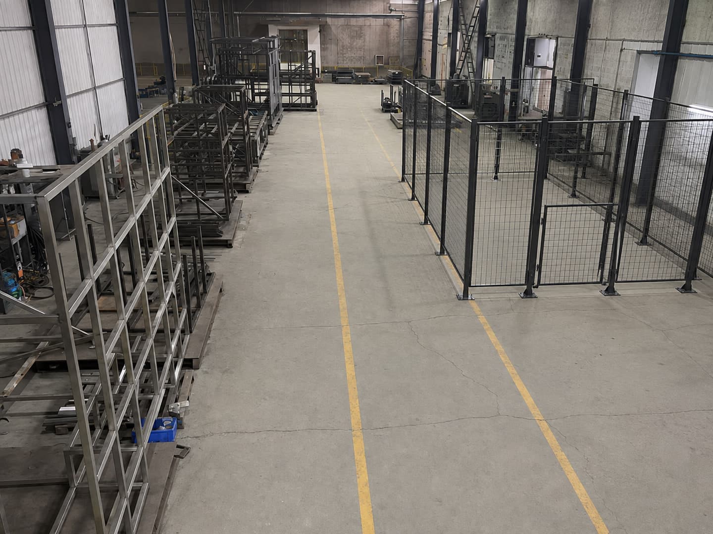 Illustrative configuration of a robot safety fence and access gate in a factory setting